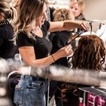 Hair stylist working on client hair